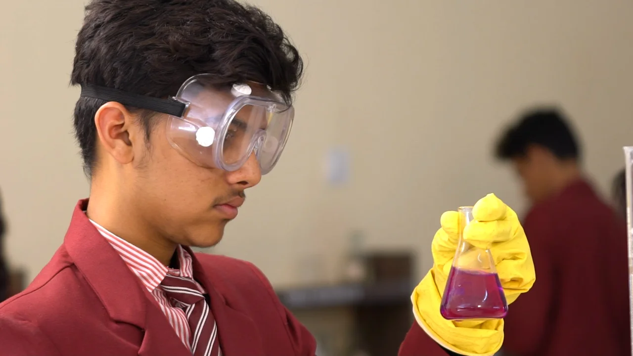 Illustrative stock scene of an Indian high-school student in a science lab